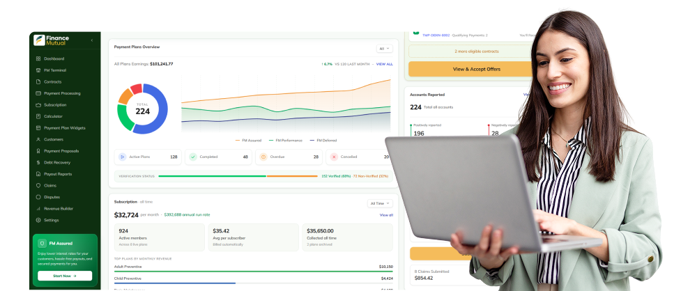 Woman holding a laptop beside a large finance dashboard showing charts and metrics on screen.